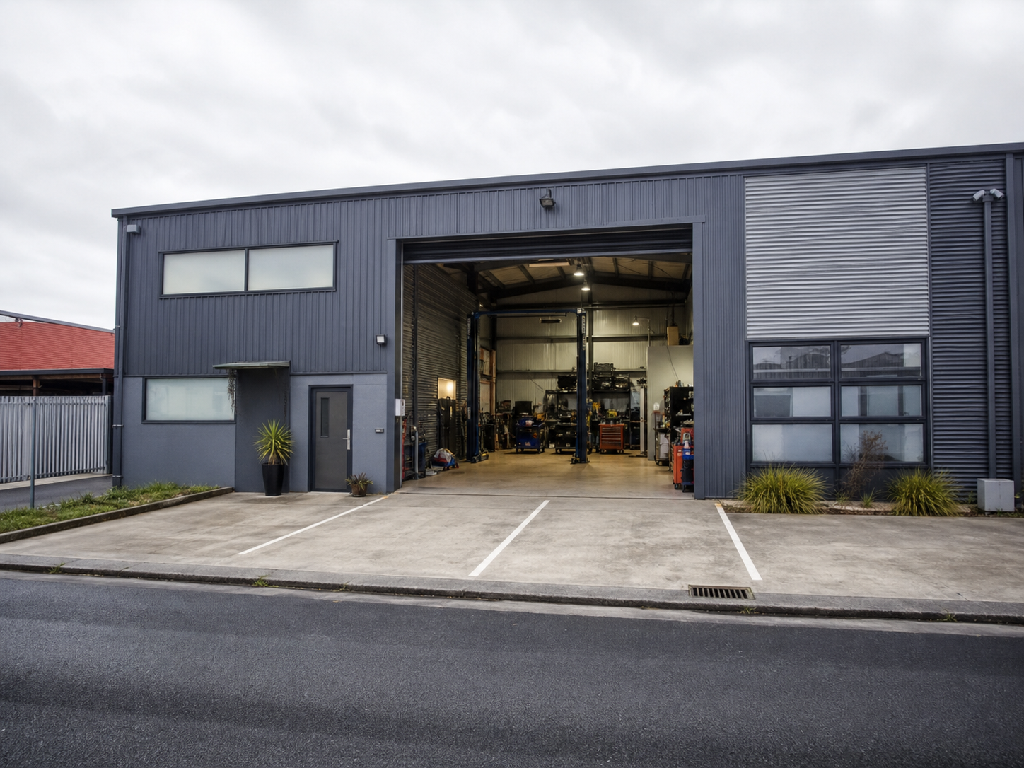 Generated placeholder showing a modest local automotive workshop exterior.
